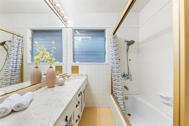 a bathroom with a granite countertop sink a toilet and shower