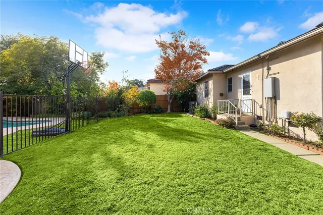a view of a house with backyard and porch