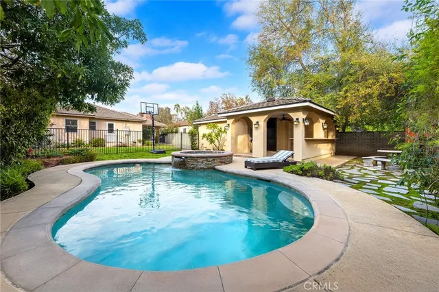 a view of a house with swimming pool and sitting area