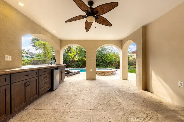 a large kitchen with kitchen island a large window in it