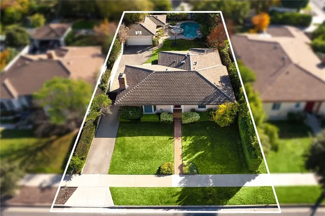 swimming pool view with a garden