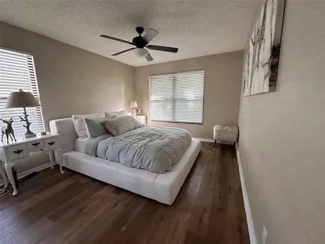 a spacious bedroom with a bed and a couch
