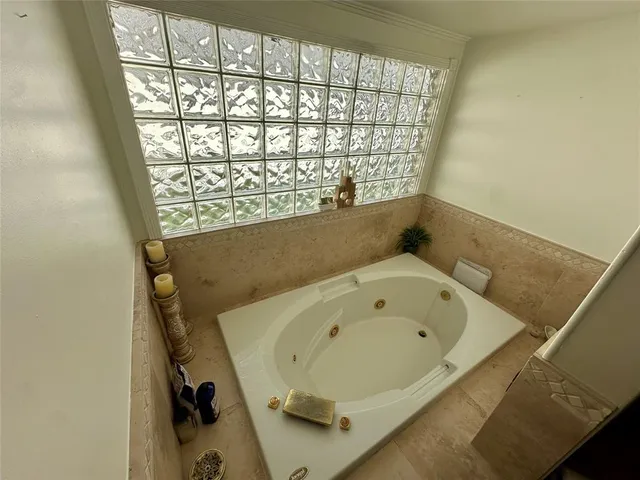 a bathroom with a bathtub and a window