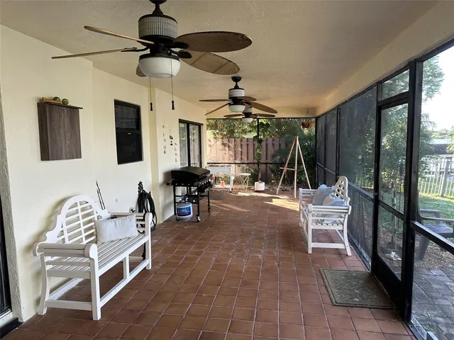 a living room with furniture a flat screen tv and a large window