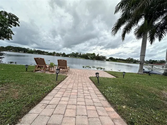 swimming pool view with a garden