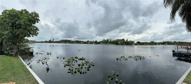 an aerial view of a houses with a lake view