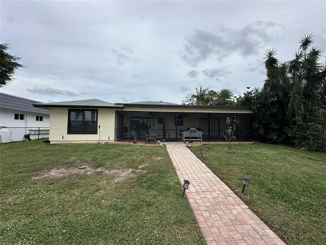 a front view of a house with a garden and yard