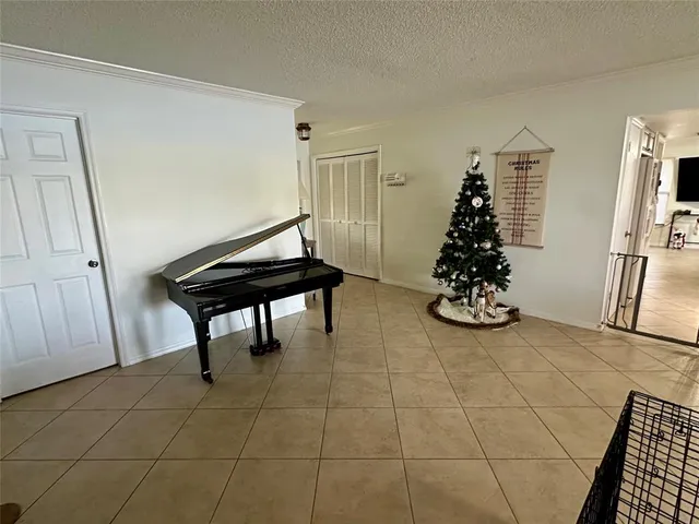 a view of a room with furniture and floor to ceiling window