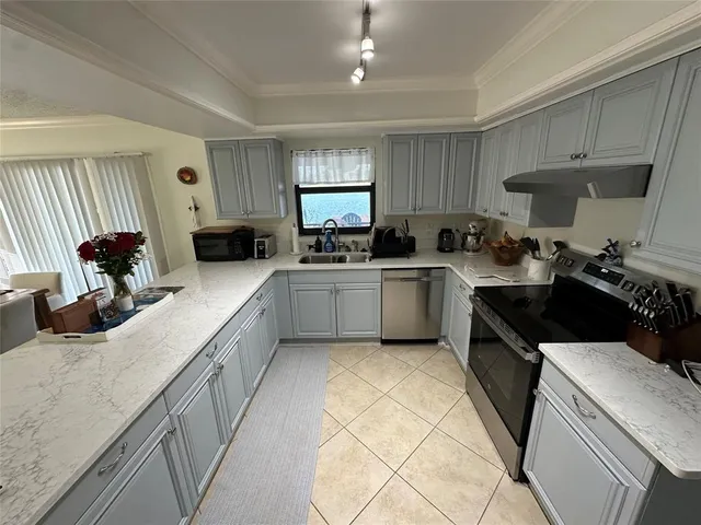 a kitchen with a sink a stove and cabinets