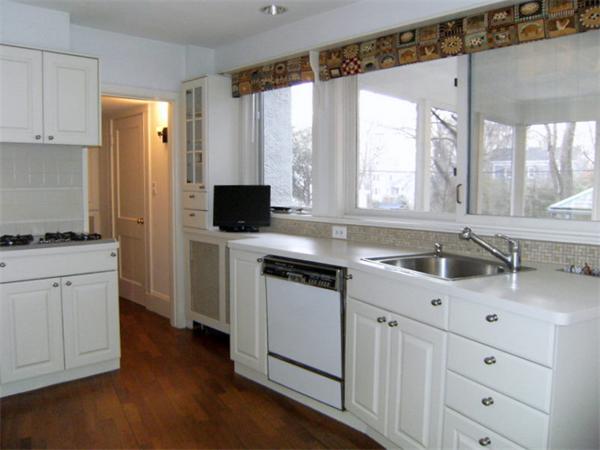 41 Prentice Road Newton, MA 02459 - Photo 7 of 28 a kitchen with white cabinets and appliances