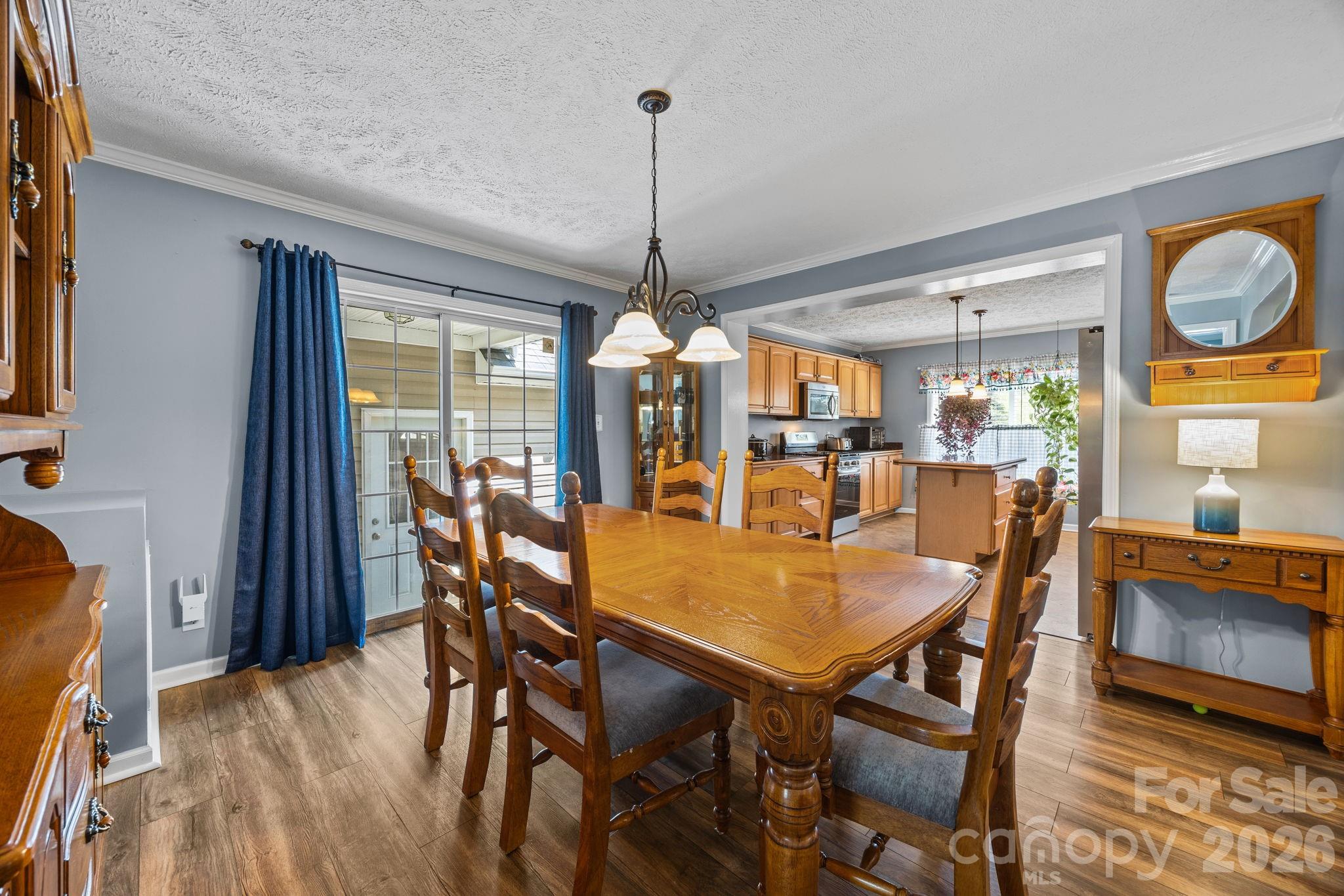 19807 Alpine Road Albemarle, NC 28001 - Photo 11 of 40 a dining room with furniture a chandelier and wooden floor