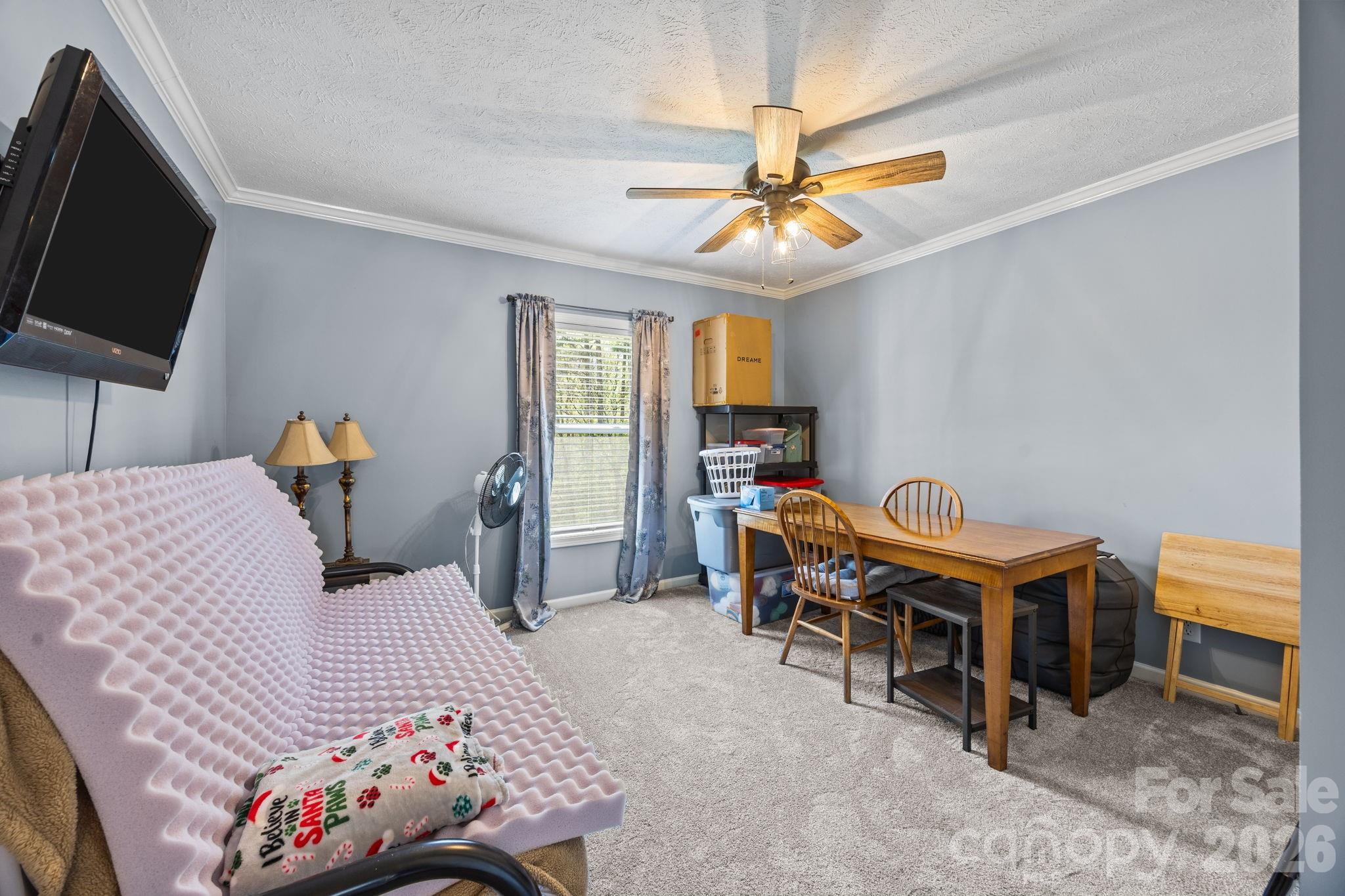 19807 Alpine Road Albemarle, NC 28001 - Photo 19 of 40 a bedroom with a bed and a chandelier