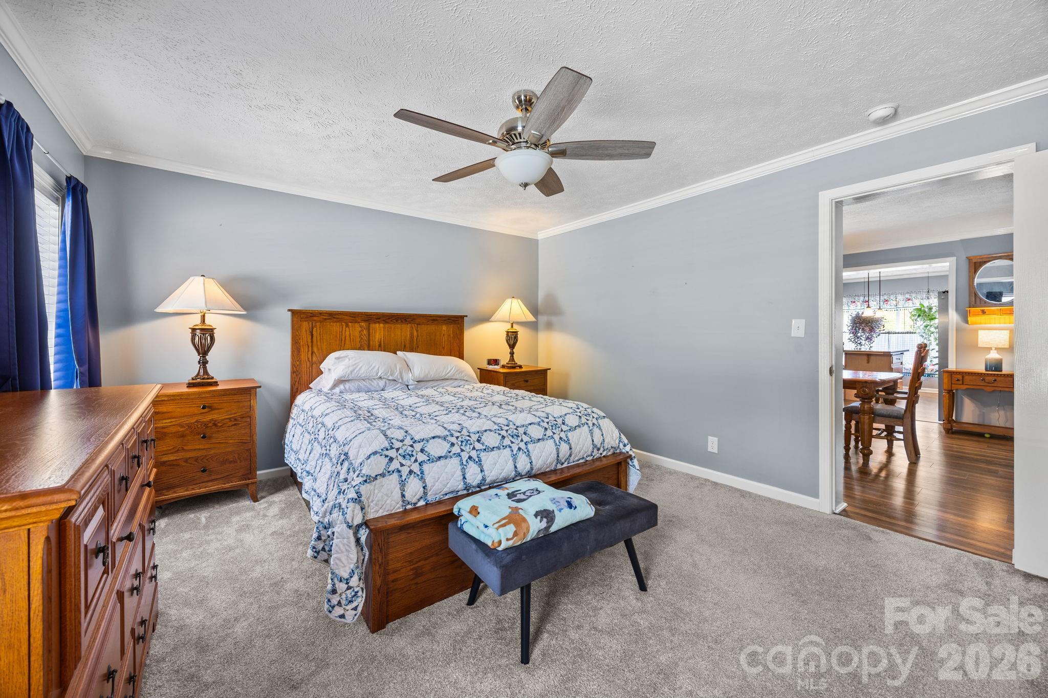 19807 Alpine Road Albemarle, NC 28001 - Photo 22 of 40 a bedroom with a bed and a chandelier