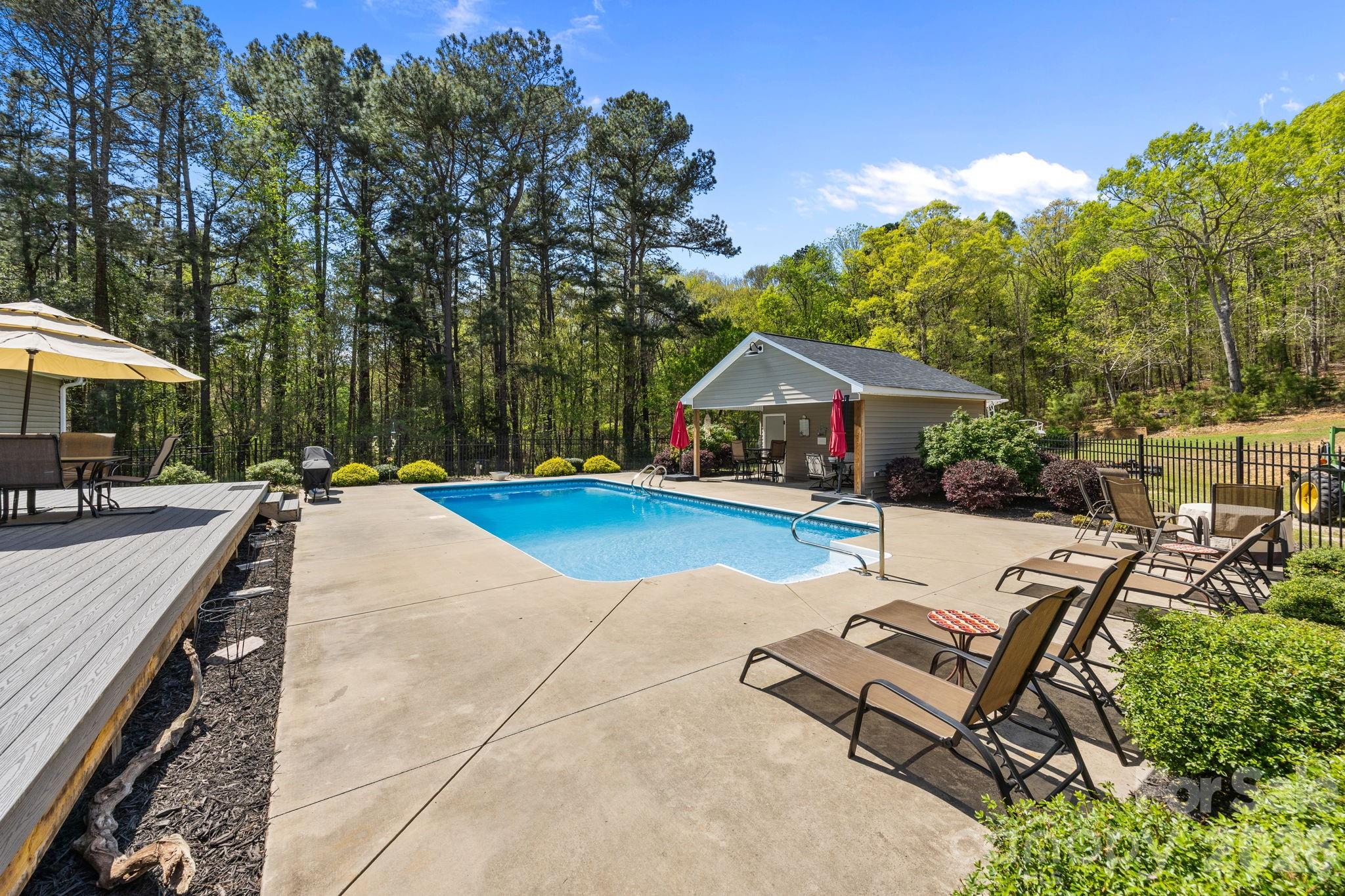 19807 Alpine Road Albemarle, NC 28001 - Photo 32 of 40 an outdoor space with furniture and umbrella