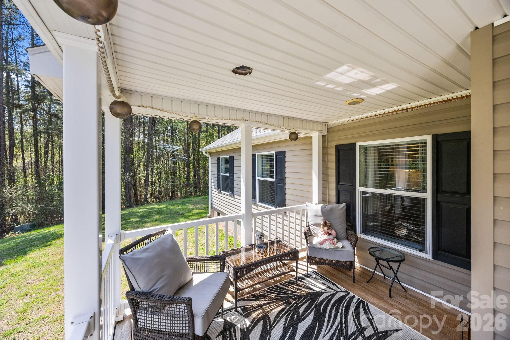 19807 Alpine Road Albemarle, NC 28001 - Photo 4 of 40 a view of balcony with furniture and floor to ceiling window