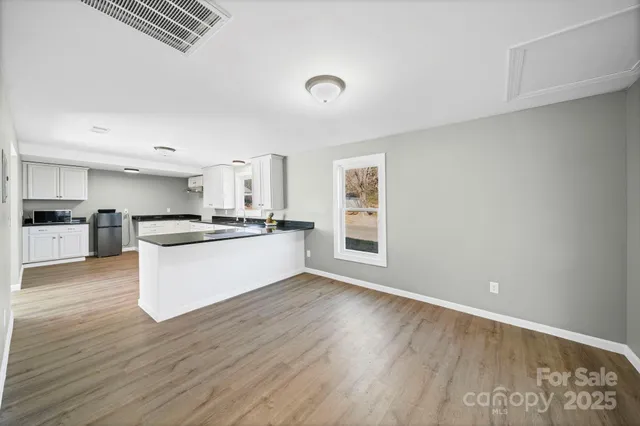 a view of kitchen with wooden floor
