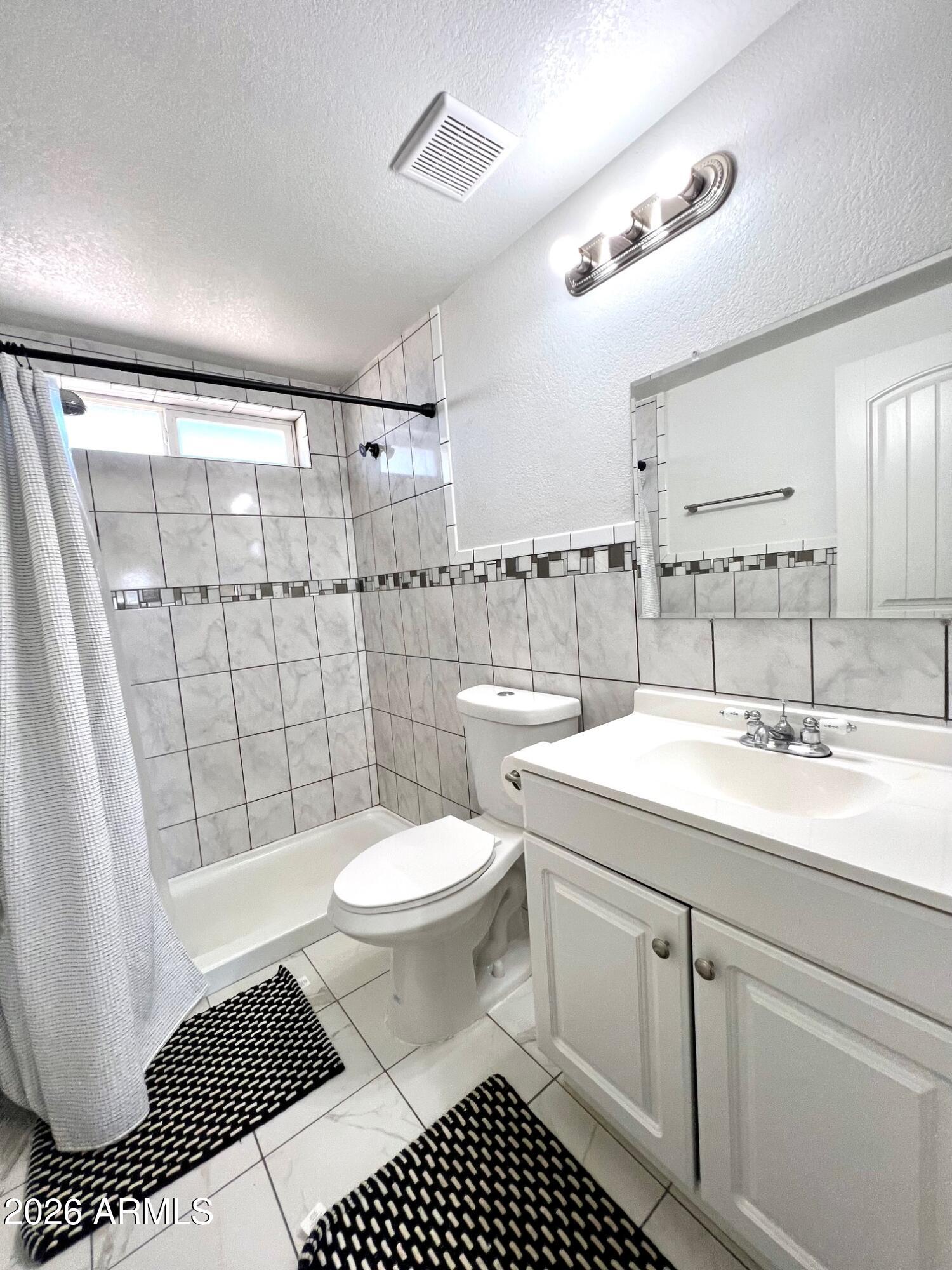 12035 East Tennyson Road Florence, AZ 85132 - Photo 6 of 42 a bathroom with a sink toilet and shower