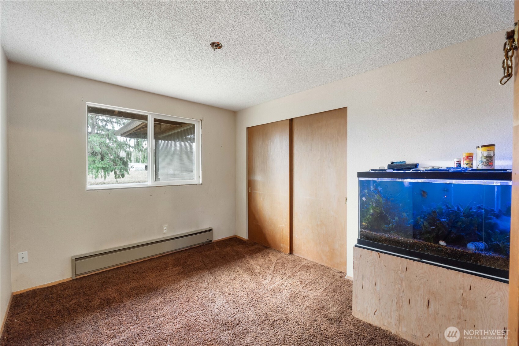29621 Webster Road East Graham, WA 98338 - Photo 18 of 35 a view of an empty room with wooden floor and window
