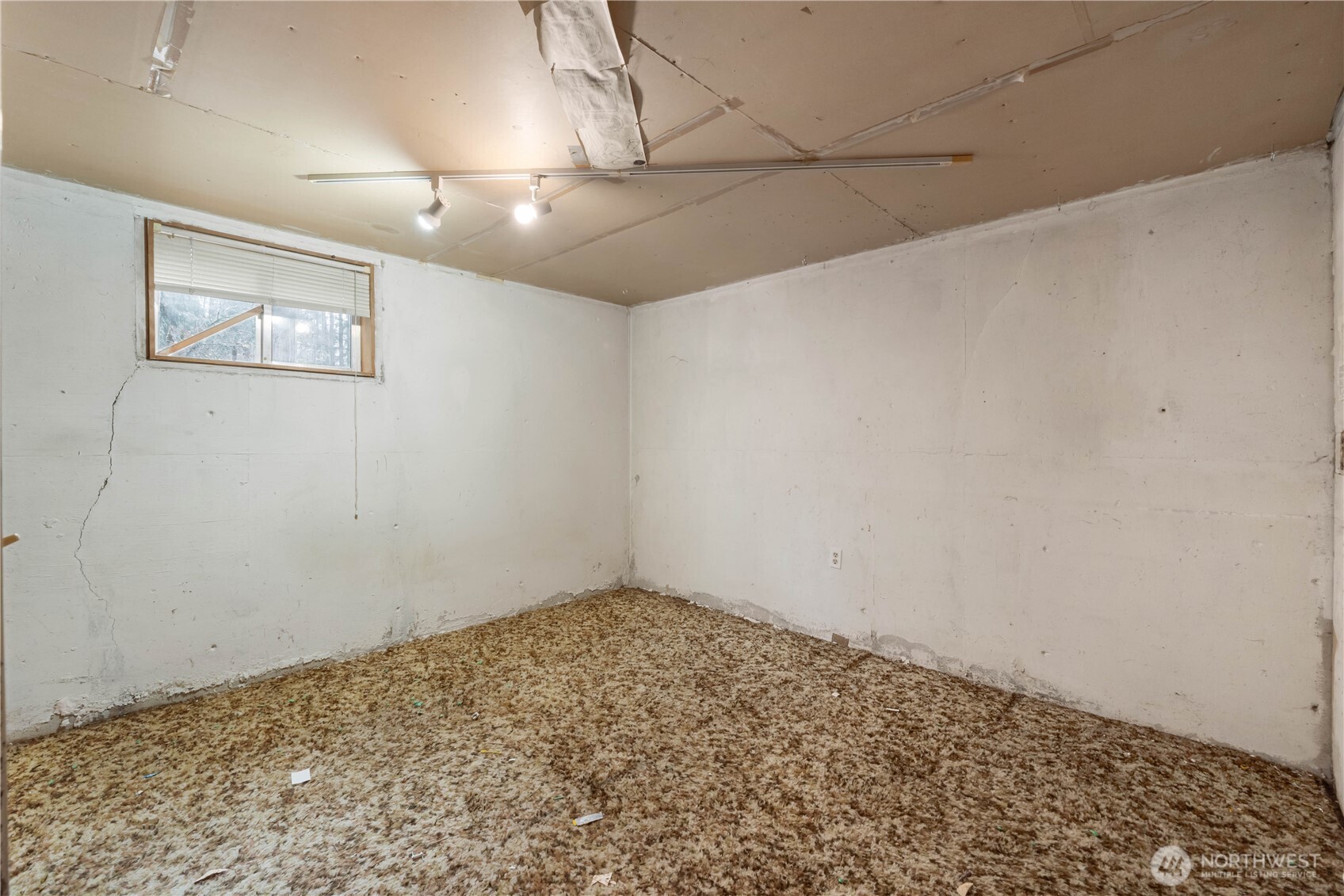 29621 Webster Road East Graham, WA 98338 - Photo 23 of 35 an empty room with a chandelier fan