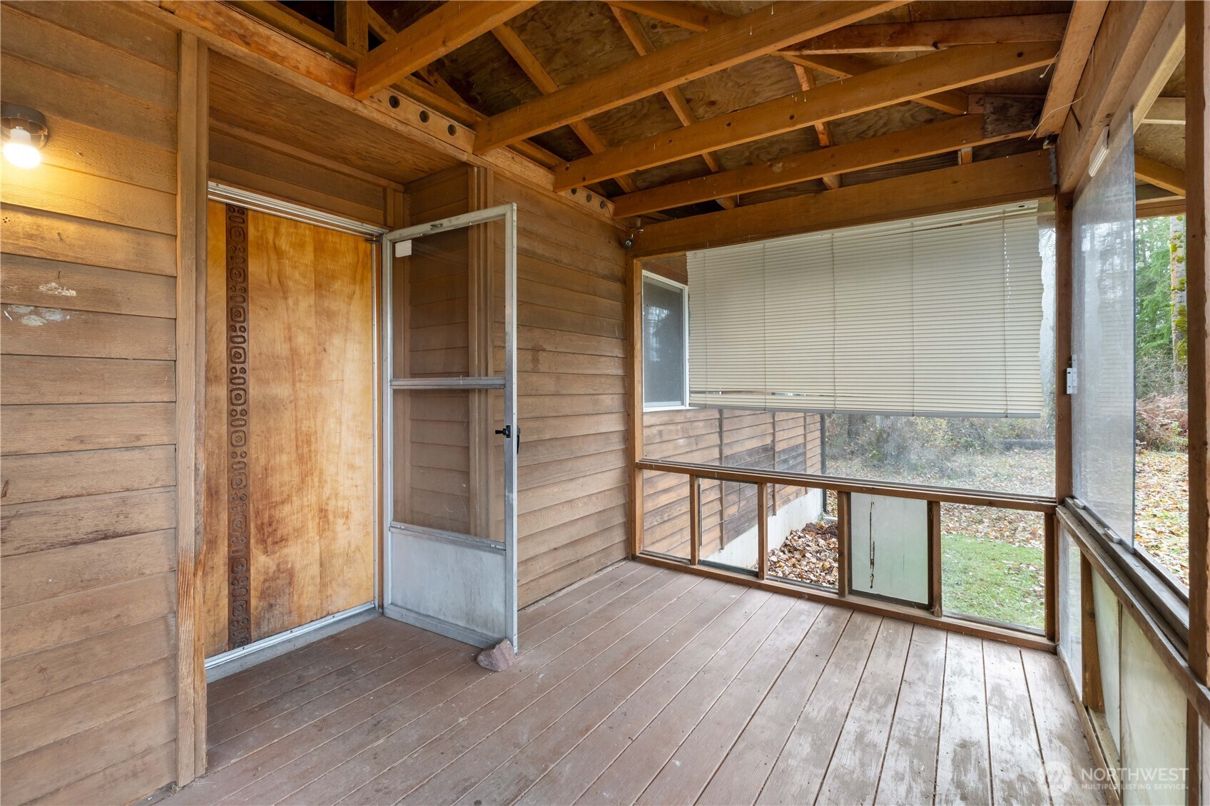 29621 Webster Road East Graham, WA 98338 - Photo 4 of 35 a view of an empty room with wooden floor and a window