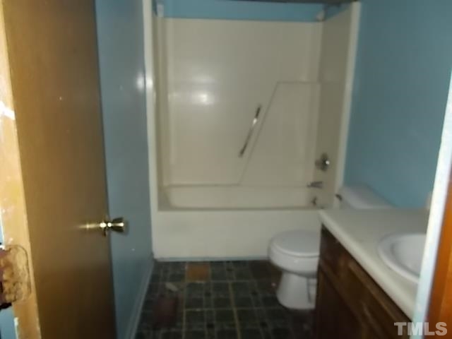 831 Horton Road Durham, NC 27704 - Photo 7 of 8 a bathroom with a granite countertop bathtub shower