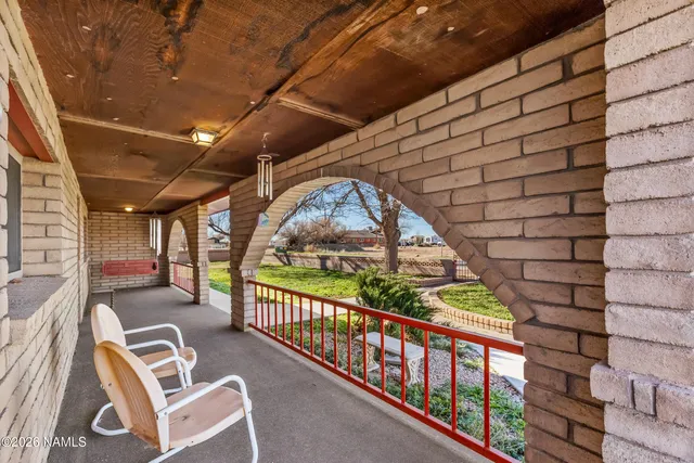 a view of empty room with wooden floor and fireplace
