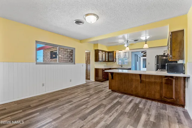 a view of a house with backyard and parking