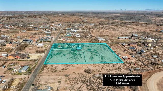 a view of a house with a yard covered in snow