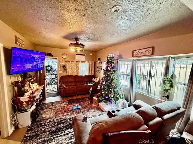 a living room with furniture and a floor to ceiling window