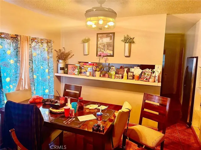a view of a dining room with furniture and a large window