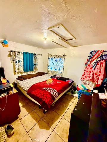 a bedroom with a bed and a painting on the wall