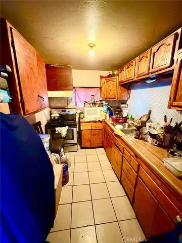 a kitchen with stainless steel appliances a stove a sink and a refrigerator