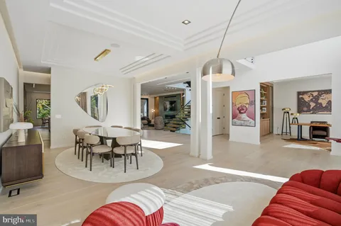 a bedroom with furniture and a large window