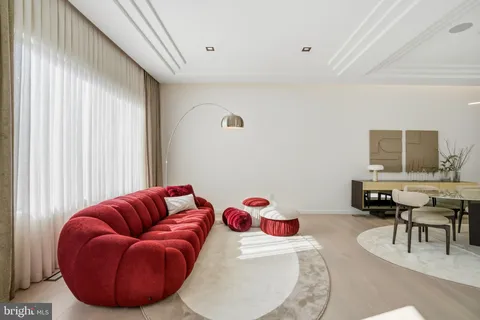a living room with furniture a rug and a flat screen tv