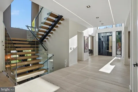 a living room with furniture fireplace and a large window