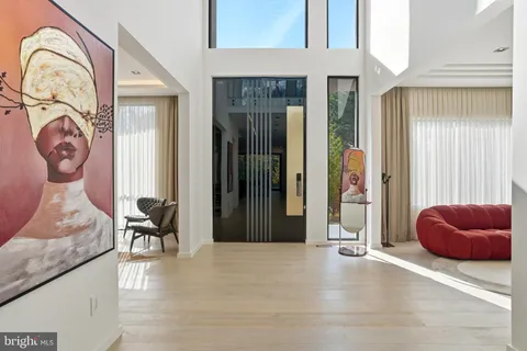 a view of a hallway with workspace and livingroom view