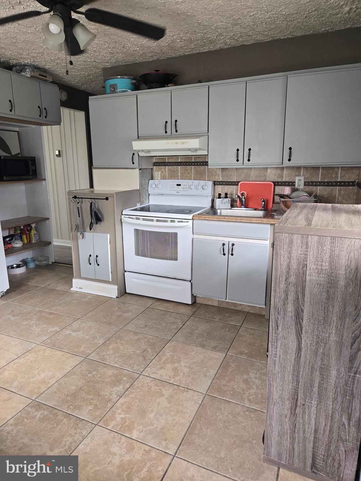 1492 Faulkland Road Wilmington, DE 19805 - Photo 6 of 23 a kitchen with cabinets and white appliances