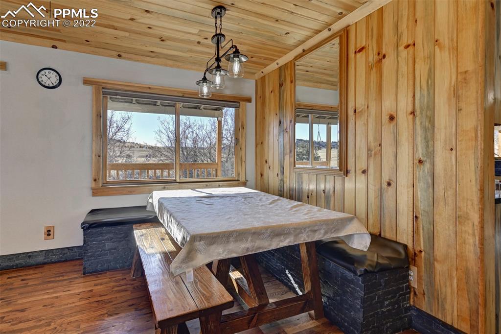 8225 3 R Road Beulah, CO 81023 - Photo 15 of 41 a dining room with wooden floor windows and chandelier