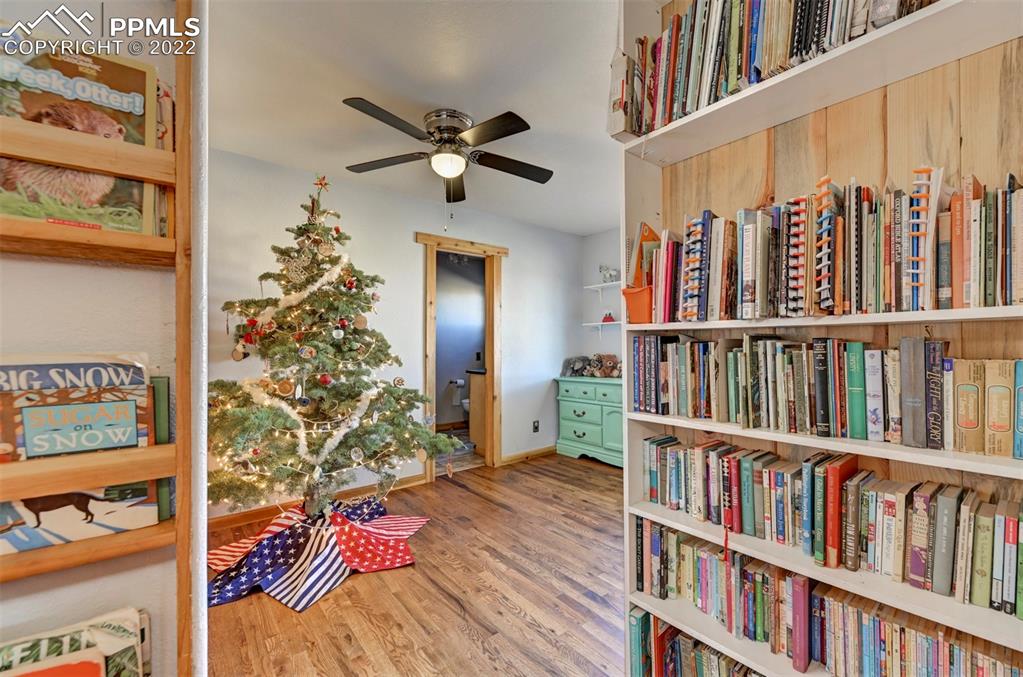 8225 3 R Road Beulah, CO 81023 - Photo 26 of 41 a living room with lots of books and a book shelf