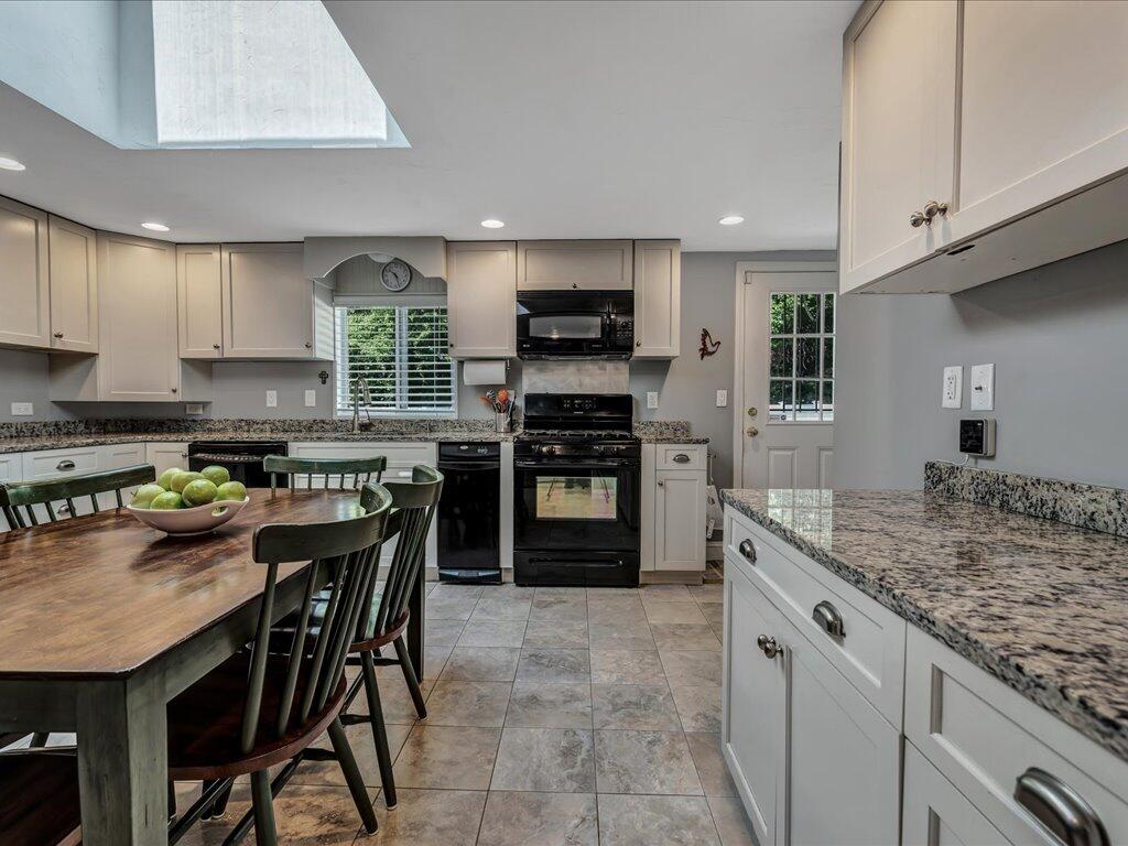 1309 Shootflying Hill Road Centerville, MA 02632 - Photo 11 of 52 a kitchen with granite countertop a stove and cabinets