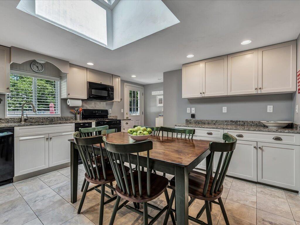 1309 Shootflying Hill Road Centerville, MA 02632 - Photo 12 of 52 a view of a dining room with furniture and a kitchen