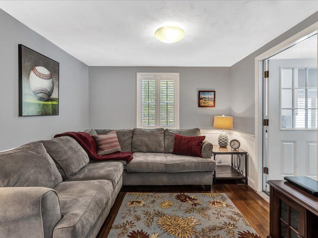 1309 Shootflying Hill Road Centerville, MA 02632 - Photo 17 of 52 a living room with a couch and a window