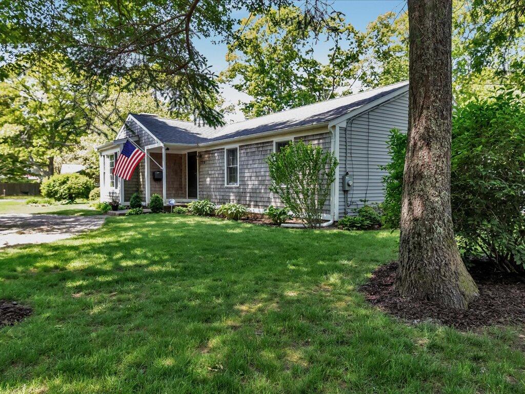 1309 Shootflying Hill Road Centerville, MA 02632 - Photo 2 of 52 a view of house with a yard