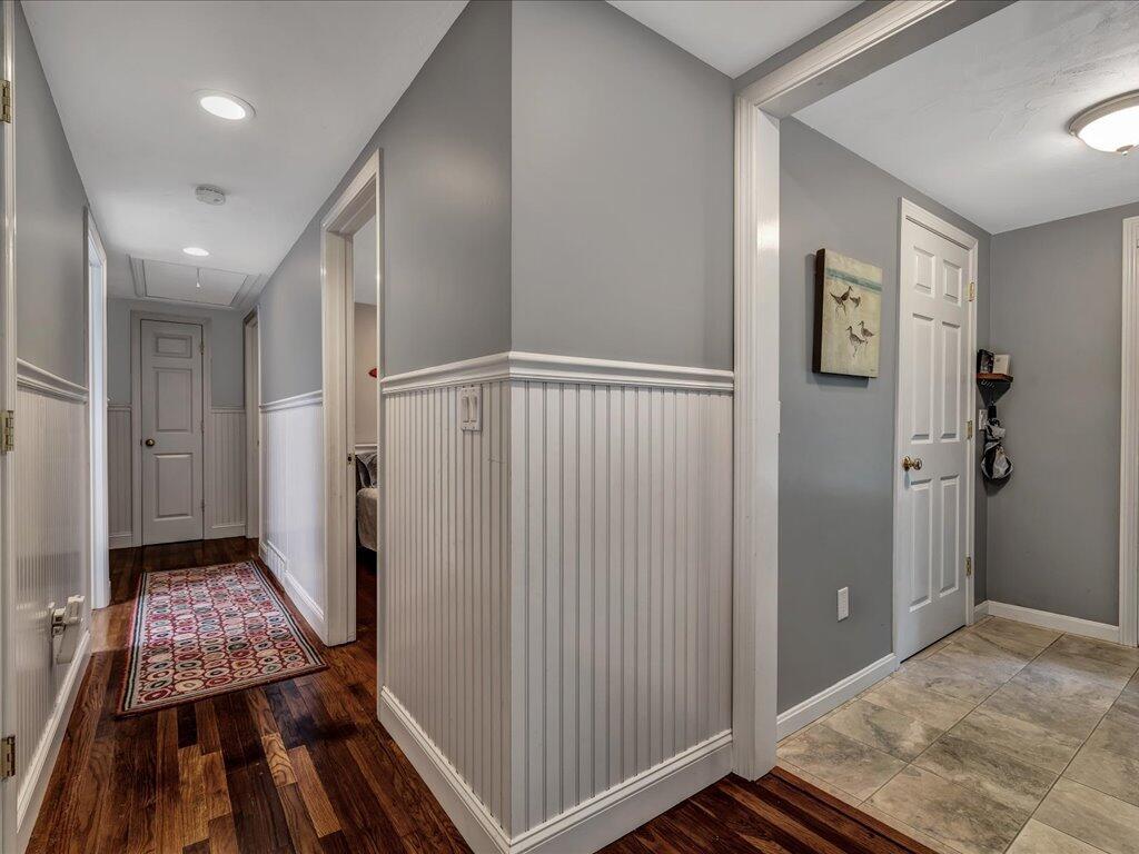 1309 Shootflying Hill Road Centerville, MA 02632 - Photo 22 of 52 a view of a hallway to a room with wooden floor and stairs