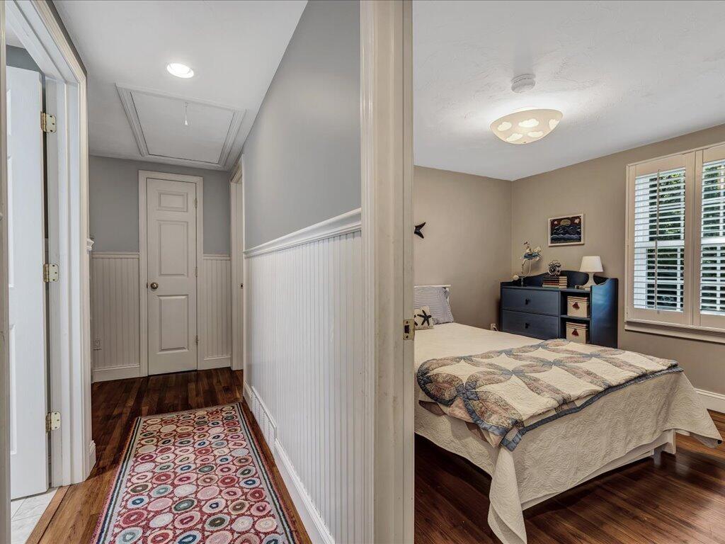 1309 Shootflying Hill Road Centerville, MA 02632 - Photo 23 of 52 a bedroom with a bed and wooden floor