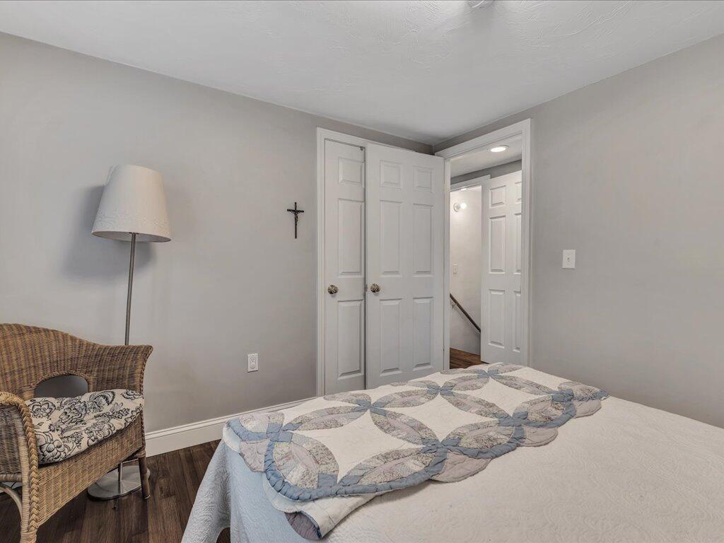 1309 Shootflying Hill Road Centerville, MA 02632 - Photo 25 of 52 a bedroom with a bed and a chair