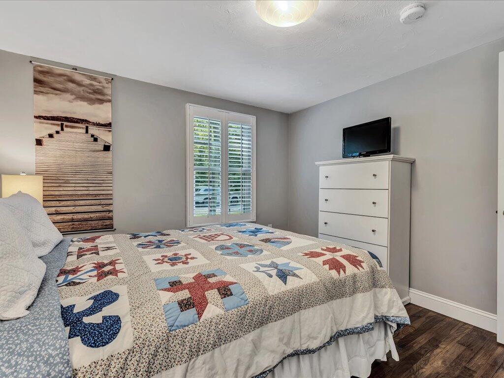 1309 Shootflying Hill Road Centerville, MA 02632 - Photo 27 of 52 a bedroom with a bed and a flat screen tv