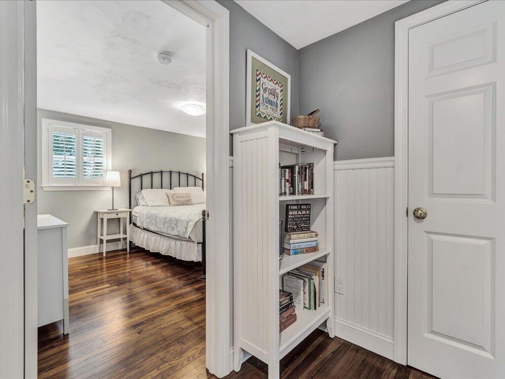 1309 Shootflying Hill Road Centerville, MA 02632 - Photo 32 of 52 a room with a bed and a book shelf