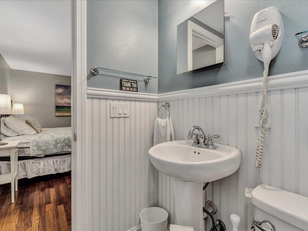 1309 Shootflying Hill Road Centerville, MA 02632 - Photo 35 of 52 a bathroom with a granite countertop sink and a mirror