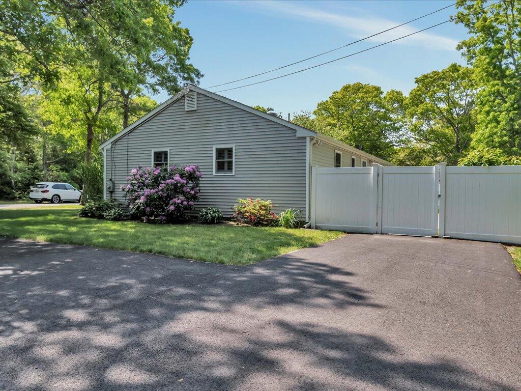 1309 Shootflying Hill Road Centerville, MA 02632 - Photo 40 of 52 a view of a house with bunch of plants